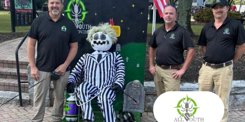 All South Pest Control team in downtown McDonough, Georgia, with the All South Pest Control logo