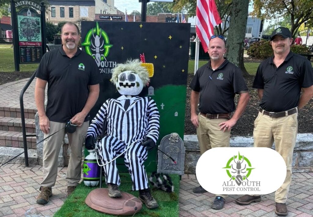 All South Pest Control team in downtown McDonough, Georgia, with the All South Pest Control logo
