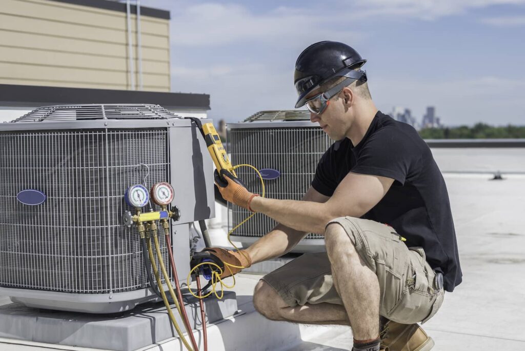HVAC technician servicing a rooftop unit