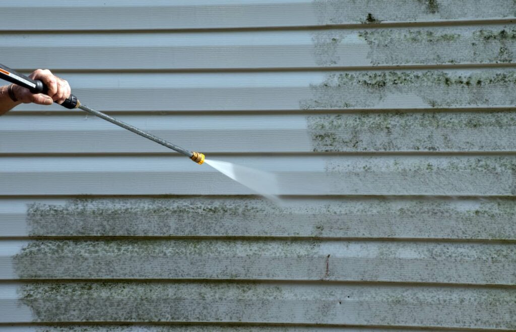 Pressure washer cleaning vinyl siding