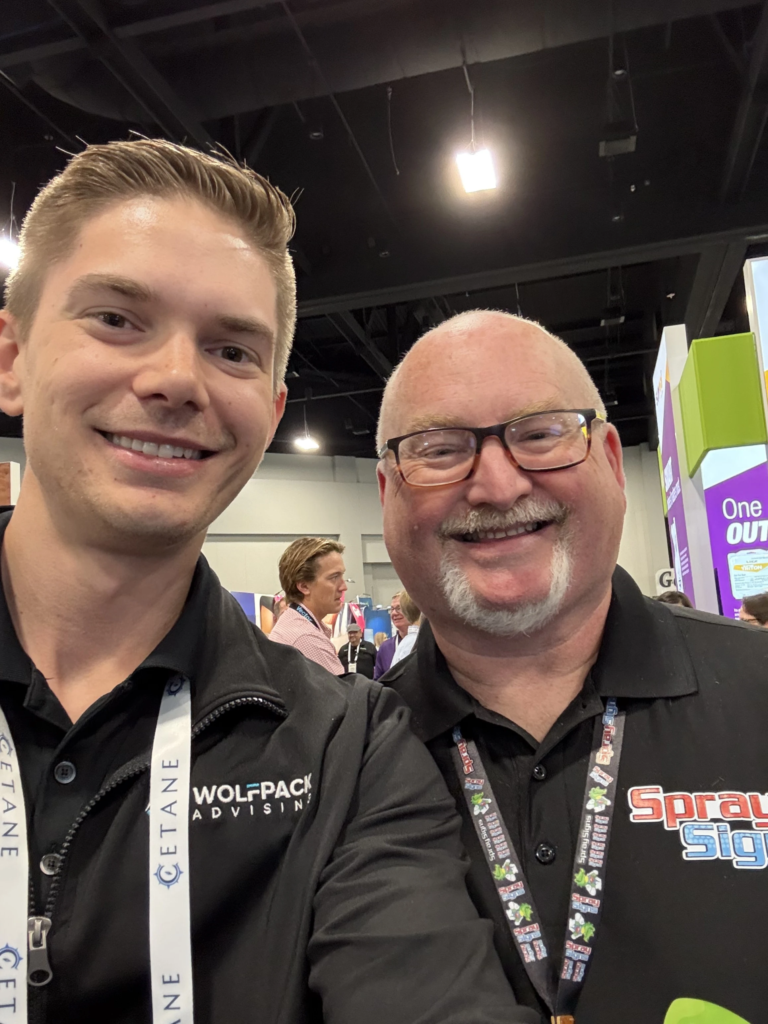 Aaron Shishilla with an attendee on a home-services expo floor