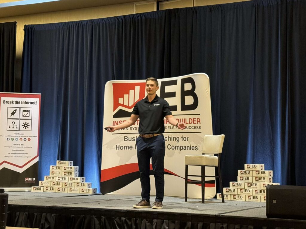 Aaron Shishilla speaking on the main stage at an Inspector Empire Builder conference