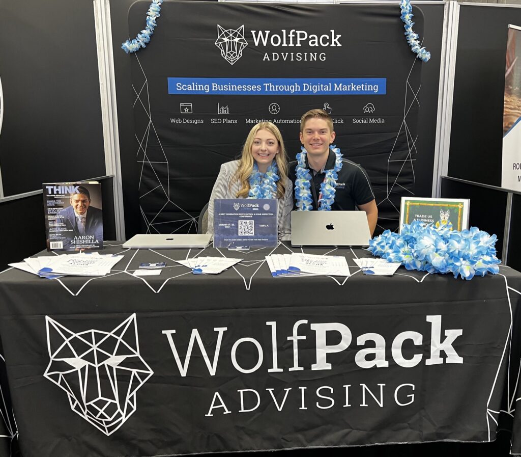 WolfPack Advising booth with two team members at an industry expo